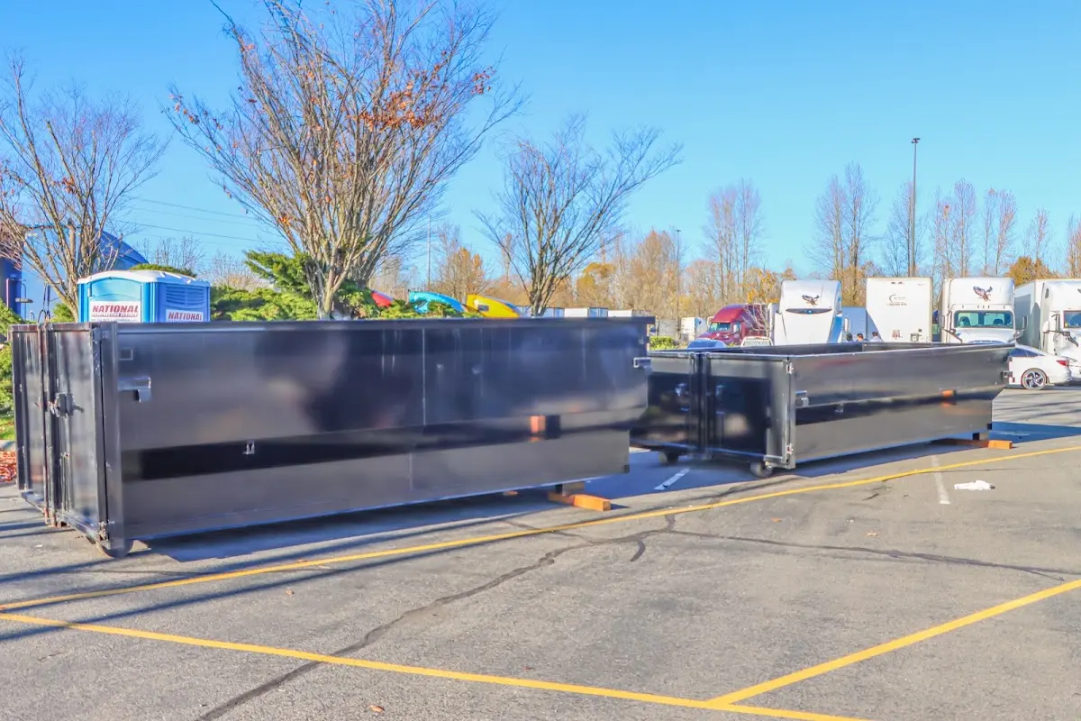 Professional dumpster rental service with roll-off container on residential driveway in Northlake